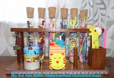 a wooden shelf filled with lots of different types of pens and paperclips