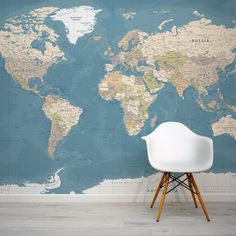 a chair sitting in front of a wall with a map on it