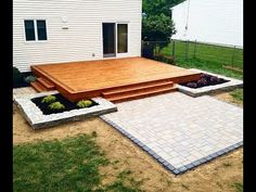 a backyard with a deck and steps in the middle