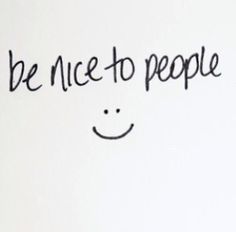 a white wall with black writing on it that says be nice to people and smiley face