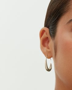 These exquisite pull-through teardrop earrings, measuring 24mm x 18mm with a 9mm opening, add an elegant touch to any look. Their distinctive shape and ideal size offer both style and comfort. Suited for any occasion, they enhance casual wear and elegantly complement dressy events, adding a touch of luxury at a great value. Materials 14K yellow gold or white gold plated. s925 Sterling Silver Posts. Measurements: Length: 24mm x 18mm; Opening: 9mm. Hypoallergenic; nickel, lead, and cadmium free.