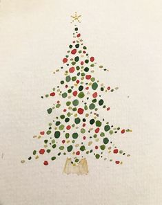 a christmas tree made out of confetti on white paper