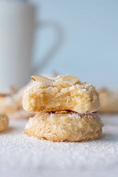 two cookies stacked on top of each other next to a cup