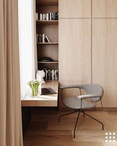 a chair and desk in front of a book shelf