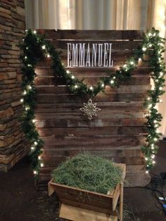 a wooden sign with lights on it that reads,'emmantee'and is surrounded by hay