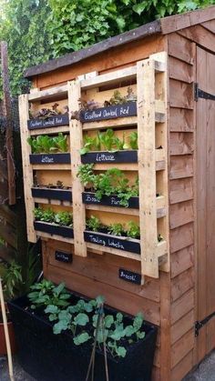 a garden shed with plants growing on the side and words written on it that read,