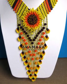 a necklace made out of beads on top of a white mannequin