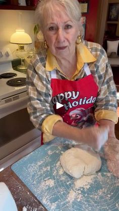 an older woman is making dough in the kitchen