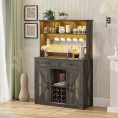 a wooden hutch with wine bottles and candles on the top, in a living room