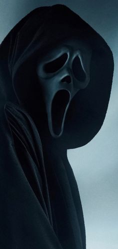 a person wearing a black mask with their mouth open and the hood pulled back over his face