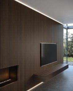 a living room with a flat screen tv mounted on the wall next to a fire place