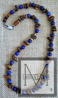 "Men's blue and brown beaded necklace is designed with blue lapis gemstone and brown rich golden tigers eye gemstone. This blue lapis is extra colorful since it is a matte finish. The blue just \"pops\" in contrast to the tiger's eye. This is a necklace with solid gemstones strung with stainless steel wire and finished off with a stainless steel clasp and wire guards. We use quality materials in our designs such as a good grade of gemstones and stainless-steel wire and clasps. Because our jewelry is not manufactured, we take the time to give you excellent beading and inspection. We keep you in mind as we are designing our jewelry, so the finished product is both durable and beautiful. We provide handsome packaging including a gift box and burlap storage bag at no extra cost. You can give a Golden Tigers, Men Necklaces, 14k Gold Initial Necklace, Mens Necklaces, Brown Beaded Necklace, Mens Beaded Necklaces, Men's Necklaces, Lapis Jewelry, Gold Letter Necklace