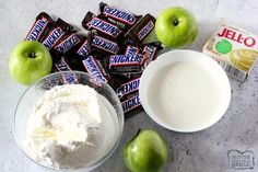 an assortment of snacks including apples, yogurt and milk