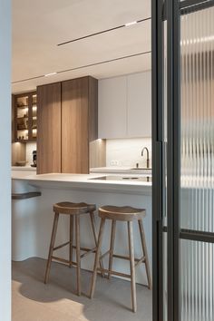 two stools sit in front of the kitchen counter