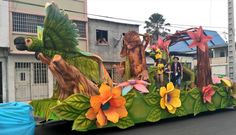 the float is decorated with flowers, birds and other things on it's side