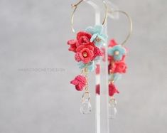 the earrings are decorated with crochet flowers