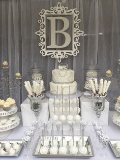 a table topped with lots of white cakes and desserts