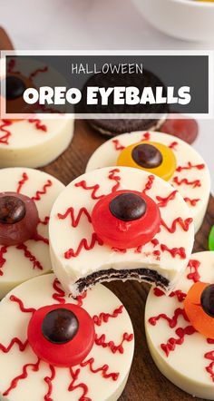 halloween oreo eyeballs are decorated with white frosting and red sprinkles