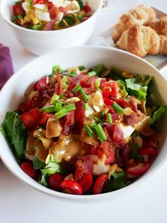 a salad in a bowl with dressing on the side