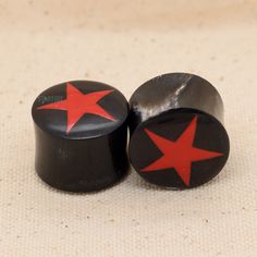 two black knobs with red stars on them