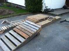 a bed made out of wooden pallets on the ground