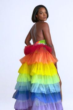 Unleash the rainbow at every turn with our Rainbow Revelry Tulle Bustle Skirt,  your ultimate dazzle piece for Pride and beyond. Why blend in when you can lead the parade in living color? This stunning skirt isn't just an accessory; it's a declaration of vibrancy and freedom, perfect for any festival, Pride march, or just when you want to turn the world into your runway. Features Include: Spectrum Cascade: Layers of tulle in every hue of the rainbow create a flowing silhouette that moves mesmerizingly with you. Versatile Charm: Adjustable, stretchy holographic rainbow ties make this skirt a comfortable fit for all, get ready to flaunt this piece with pride. Handcrafted Perfection: Each skirt is lovingly handmade, for a piece as unique as you are. Scene-Stealing Style: From parade to podium Multicolor Tulle Skirt For Summer, Rainbow Skirt For Spring Party, Tulle Bustle Skirt, Tulle Rainbow, Tulle Bustle, Plus Size Rave, In Living Color, Bustle Skirt, Halter Bodysuit