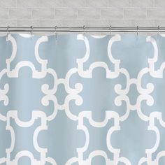 a blue and white shower curtain with an abstract design