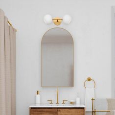 a bathroom with a sink, mirror and bathtub in it's center area