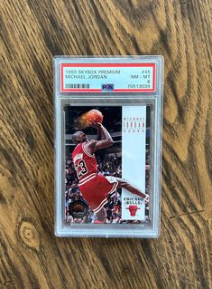 a basketball card with the name michael jordan on it is displayed in a clear plastic case