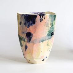 a vase is sitting on a white surface