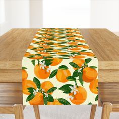 an orange print table runner sitting on top of a wooden table