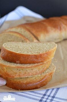 a person holding a loaf of bread in their hand