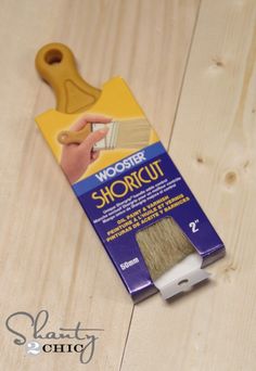 a box of wood glue sitting on top of a wooden floor