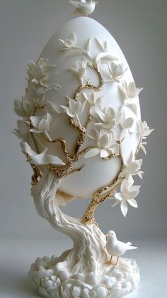 an egg decorated with white flowers and branches