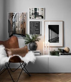 a living room filled with furniture and pictures on the wall