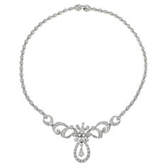 This exquisite estate necklace from the Art Nouveau era, weighing 31.93 grams, is crafted in platinum and features an elegant drop design. The necklace showcases a total of 6.00 carats of diamonds, including round and pear cut stones with G-J color and VS/SI clarity. This luxurious piece embodies the graceful and artistic style of the Art Nouveau period, making it a timeless addition to any jewelry collection. Exquisite Pear-shaped Diamond Necklace For Formal Events, Exquisite Pear-shaped Diamond Necklace For Formal Occasions, Platinum Necklaces With Diamond Accents, Pear-shaped, Classic Pear-shaped Bridal Necklace With 17 Jewels, Silver Briolette Diamond Necklace For Wedding, Formal Briolette Diamond Necklace With Brilliant Cut, Formal Briolette Brilliant Cut Diamond Necklace, Silver Platinum Pear-shaped Necklace, Pear-shaped Platinum Silver Necklace