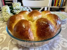 a glass dish filled with bread sitting on top of a table