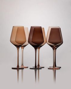 three wine glasses sitting next to each other