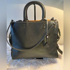 Gorgeous Coach Rogue 1941 Gvn Pbb 224221jax Glovetanned Pebble Leather In Black With Beautiful Pewter Hardwear And Suede Interior. 12 1/4”W X 9 3/4” H X 5 1-2” W. Handles Have A 3 1/2” Drop. Detachable Straps With 10” Drop For Shoulder Wear Or Can Be Linked Together For Crossbody Wear. Inside Zip Pocket And French Purse Pocket. This Bag Has Been Used Twice And Is In Practically Brand New Condition. Comes With Dust Cover And Box. Coach Leather Satchel For Fall, Coach Black Satchel For Fall, Black Coach Satchel For Fall, Black Bags With Branded Hardware For Fall, Black Pebbled Leather Satchel For Work, Fall Black Bags With Branded Hardware, Black Textured Leather Satchel For Fall, Coach Textured Leather Satchel, Black Bags With Silver-tone Hardware For Fall