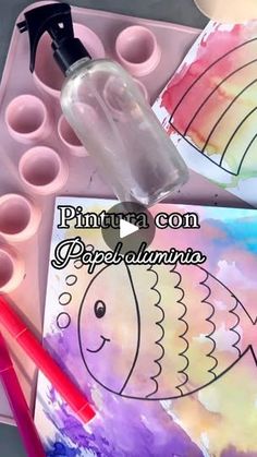 an art project for kids with watercolors and paints on it, including fish