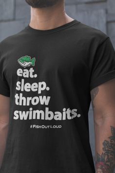 Eat. Sleep. Throw Swimbaits. Have some fun with this tshirt, then go fishing. Remember, you're just one cast away. Link to women's tshirt - https://www.etsy.com/listing/1114003917 Link to YouTube FishOutLoud - https://bit.ly/YouTubeFOLa Please Note: We do not charge shipping EVER and we offer the highest quality, highest customer review shirts anywhere. This classic unisex jersey short sleeve tee fits like a well-loved favorite. Soft cotton and quality print make users fall in love with it over and over again. These t-shirts have-ribbed knit collars to bolster shaping. The shoulders have taping for better fit over time. Dual side seams hold the garment's shape for longer.  .: 100% Airlume combed and ringspun cotton (fiber content may vary for different colors) .: Light fabric (4.2 oz/yd² ( Mens Fishing Shirts, Cheap Shirts, Fishing Shirts, Unisex Shorts, Cool Shirts, Mens Gifts, Short Sleeve Tee, Print Quality, Fish