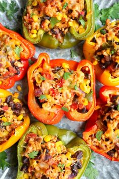 stuffed bell peppers with black beans, corn and rice in them on a foil wrapper