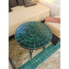 a green table sitting on top of a tiled floor