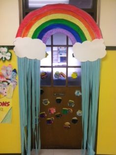 the door is decorated with rainbows and clouds