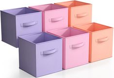 four different colored storage bins with handles on each side and one in the middle