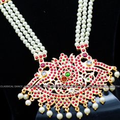 Original Design by Classical Dance Jewelry® ❥ Pearl Kempu Long Haram Chain is traditional and ethnic South Asian Indian Jewelry. ❥ 4 lines Open Peacock Style Pendant Pearls Long Necklace. ❥ You Can wear this set for Bharatnatyam Kuchipudi Dance Performances, Engagement, Weddings, Birthdays, festivals, puja, Ammavaru Amman decorations, Durgamata Decoration ❥ Handmade Indian Traditional Item. ❥❥❥ Set has variations please CHECKOUT Variants ☛ Long Necklace with earrings ☛ Long Necklace without earr Traditional Red Bridal Necklace For Puja, Traditional Multicolor Mala For Puja, Bollywood Style Temple Necklace With Peacock Design For Diwali, Bollywood Temple Necklace With Peacock Design For Diwali, Bollywood Style Kundan Necklace With Peacock Design For Ceremonial, Festive Traditional Kundan Necklace With Peacock Design, Traditional Kundan Necklace With Motifs For Celebration, Traditional Red Kundan Necklace For Navratri, Bollywood Style Peacock Temple Necklace For Festive Occasions