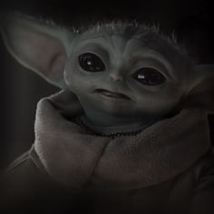 the baby yoda is looking at the camera