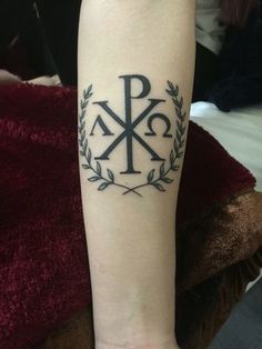 a person with a tattoo on their arm that has the letters k and p in it