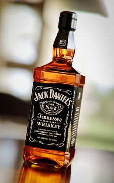 a bottle of jack daniels whiskey sitting on top of a table