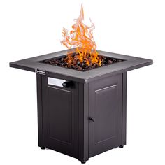 an outdoor fire pit sitting on top of a metal table with flames coming out of it